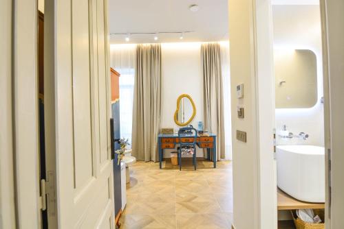a bathroom with a tub and a sink and a mirror at Evilion Suites in Xylokastro