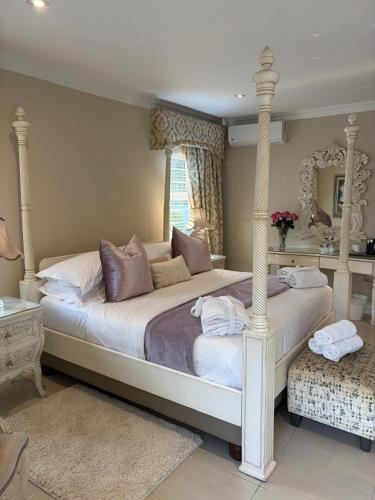 a bedroom with a large bed with a canopy at Luxury Beach Apartments in Amanzimtoti