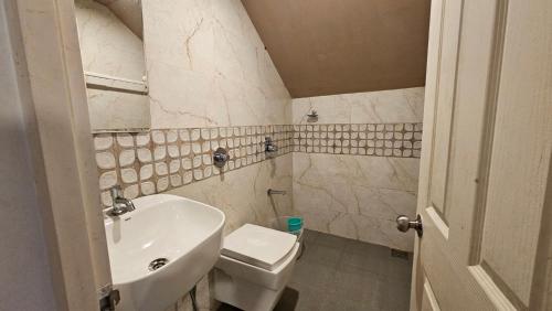 a small bathroom with a sink and a toilet at Celestial Nymph by Natureloom in Vagamon