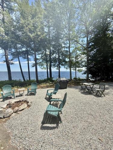a group of chairs and picnic tables in a park at PLACYD PINES LIMIT 8 cottage in North Sebago