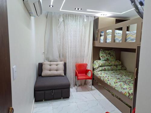 a small bedroom with a bed and a chair at شاليه غرفتين ببورتوسعيد للعائلات فقط in Port Said
