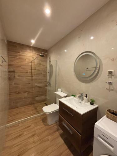a bathroom with a sink and a toilet and a shower at Ionian Port Suite in Ágios Rókkos