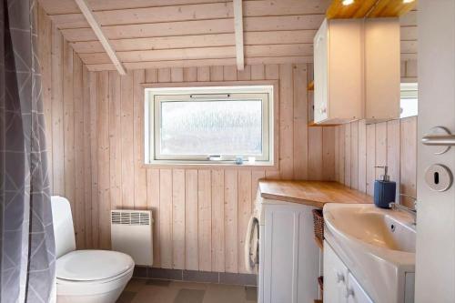a small bathroom with a toilet and a sink at FY187-Asperup-Bogevangsvej-1 in Asperup