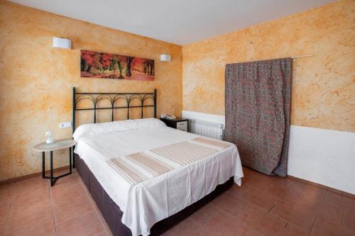 a bedroom with a large bed and a window at San José Moratalla in Moratalla