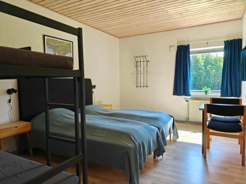 a bedroom with two bunk beds and a window at Nordgården Pension in Onsbjerg