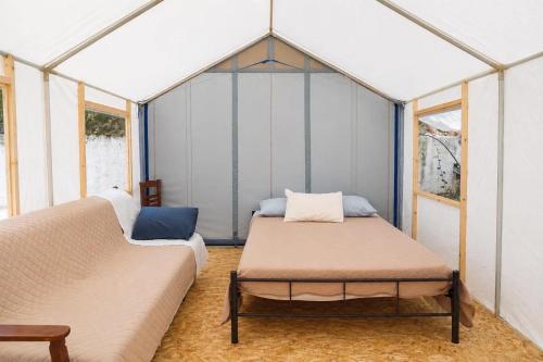 a room with two beds in a tent at XeniCamp & Bungalows in Tolo