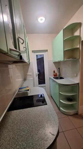 a kitchen with green cabinets and a counter top at Cottages Delloress in Jūrmala