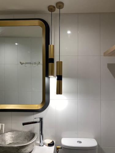 a bathroom with a sink and a mirror at Happinest Private Apartment II in Kalymnos