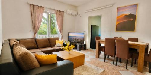 a living room with a couch and a dining room at Rakovica Resort in Sarajevo
