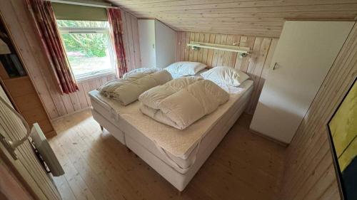 a small bed in a small room with a window at 30035-Malling-Pilelokken-16 in Malling