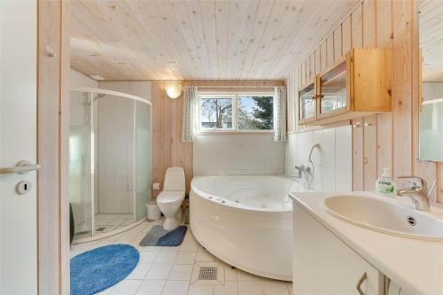 a bathroom with a tub and a sink and a toilet at 30035-Malling-Pilelokken-16 in Malling