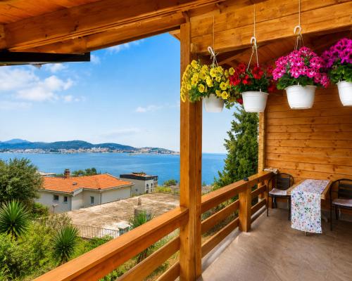 a balcony with flowers and a view of the ocean at Sea View Luxury Chalet in Šušanj