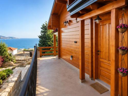 a porch of a house with a view of the ocean at Sea View Luxury Chalet in Šušanj