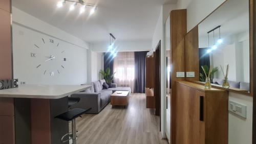 a living room with a couch and a clock on the wall at Vivo in Jagodina