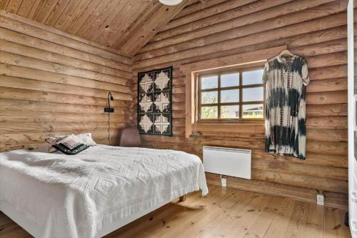 a bedroom with a bed in a wooden room at 30118-Odder-Pouli-Nielsensvej-27 in Odder