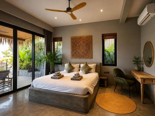 a bedroom with a bed and a desk and a chair at SANA Koh Phangan in Salad Beach