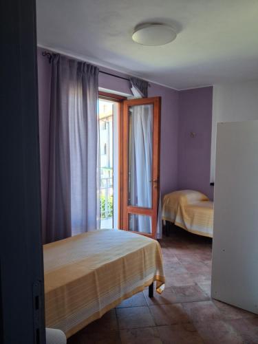 a bedroom with a bed and a window at Il Borghetto in Castano Primo