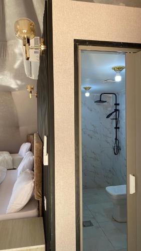 a room with a bathroom with a bed and a sink at FLORA RUM LUXURY CAMP & Bubble Hotel in Wadi Rum