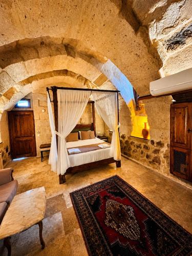 a bedroom with a bed in a stone room at Zuwinasa House Hotel in Avanos