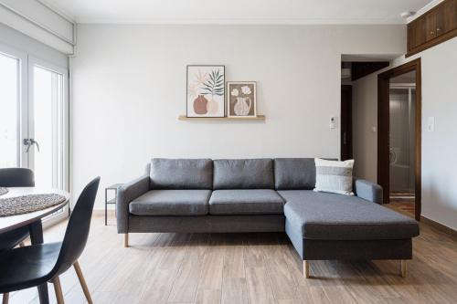 a living room with a couch and a table at NIMA Mytikas Apartments - Aitoloakarnania in Mitika
