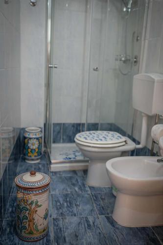 a bathroom with two toilets and a shower at Artemide B&B in Caltagirone