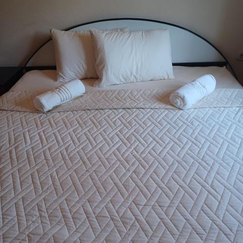 a large white bed with two pillows on it at Apartman Katić - Rental Home in Stolac