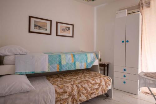 a bedroom with a bed and a dresser at Artemide B&B in Caltagirone