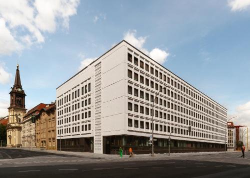 a white building on the corner of a street at Limehome Berlin Klosterstraße in Berlin