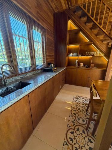 a large kitchen with a sink and a table at The BENAWAH Villa in Tegalalang