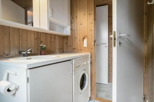a bathroom with a washing machine and a sink at 30586-Odder-Tvaeragervej-7 in Odder