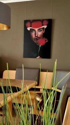 a table with a picture of a woman on the wall at Fewo Schwarzwald Von Oben - Kniebis in Freudenstadt