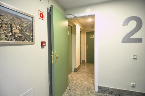 a hallway with the number on the wall at Hotel Apartamentos Aralso in Segovia