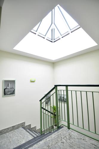 a skylight in the ceiling of a building with stairs at Hotel Apartamentos Aralso in Segovia