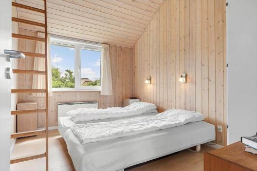 a bedroom with two beds and a window at 1132-Ringkobing-Hvidbjergvej-32 in Søndervig