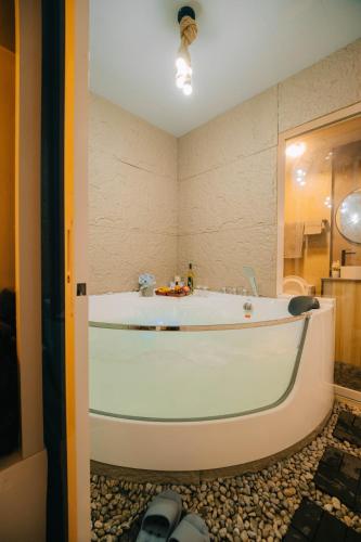 a bathroom with a large tub in a room at G-Luxe Panabo Guesthouse - Unit B in Panabo