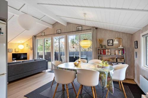 a kitchen and dining room with a table and chairs at 239-Ringkobing-Vestklitvej-32 in Klegod