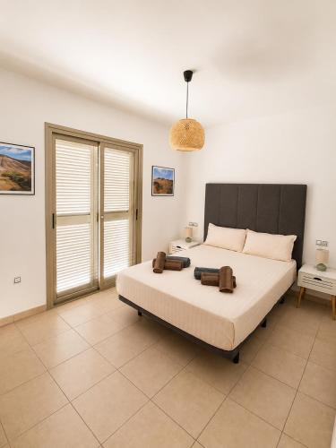 a bedroom with a large bed in a room at Aurea 1 Luxury House in Antigua
