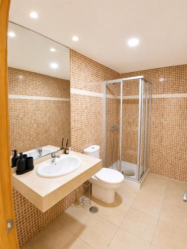 a bathroom with a toilet and a sink and a shower at Aurea 1 Luxury House in Antigua