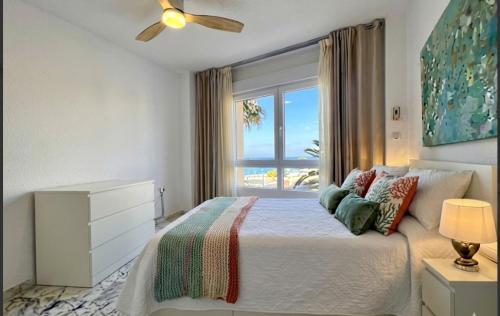 a bedroom with a bed and a large window at Sunset Torrox Costa in Torrox