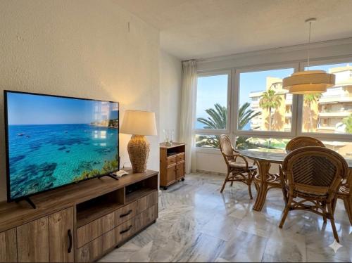 a living room with a large flat screen tv at Sunset Torrox Costa in Torrox