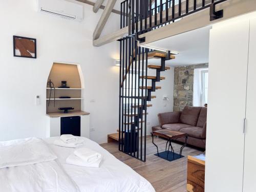 a bedroom with a bed and a spiral staircase at Gloria Holiday - Villa di Istria in Piran