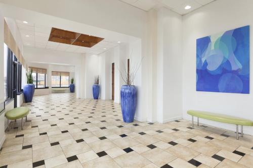 a hallway with blue vases on the floor at DoubleTree by Hilton Corpus Christi Beachfront in Corpus Christi