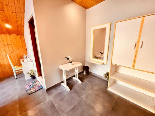 a bathroom with a sink and a mirror at Hadimba Palace, Manali in Manāli