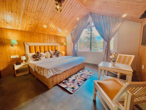 a bedroom with a large bed with a wooden ceiling at Hadimba Palace, Manali in Manāli