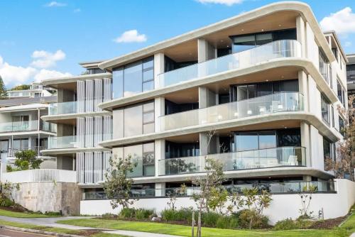 an apartment building with balconies on a street at Coolum First Bay 121 in Coolum Beach