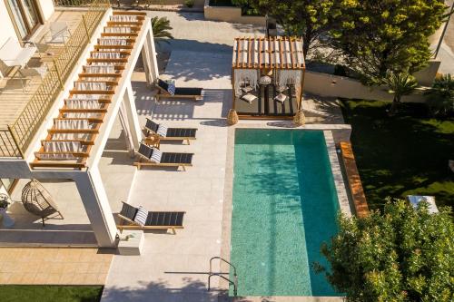 an overhead view of a swimming pool with chairs and stairs at Kallisti Luxury Villa in Kallithea Rhodes