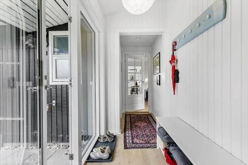 a hallway with white walls and a staircase with a door at 84159-Ebeltoft-Koravej-5 in Ebeltoft