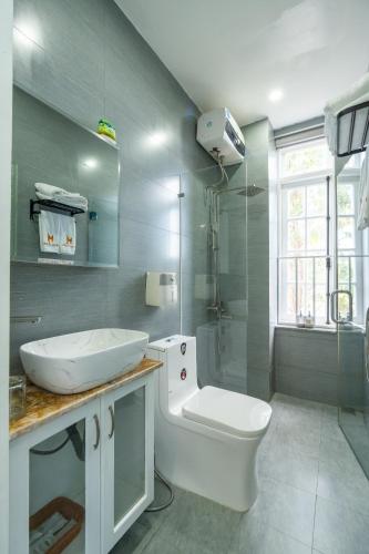 a bathroom with a toilet and a sink and a shower at May Bliss Villa in Danang