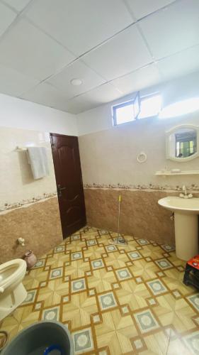 a bathroom with a toilet and a sink at Luxury Apartment in Khaira Gali