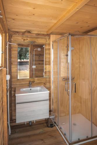 a bathroom with a sink and a shower at Glamping Masseria Cuturi in Manduria